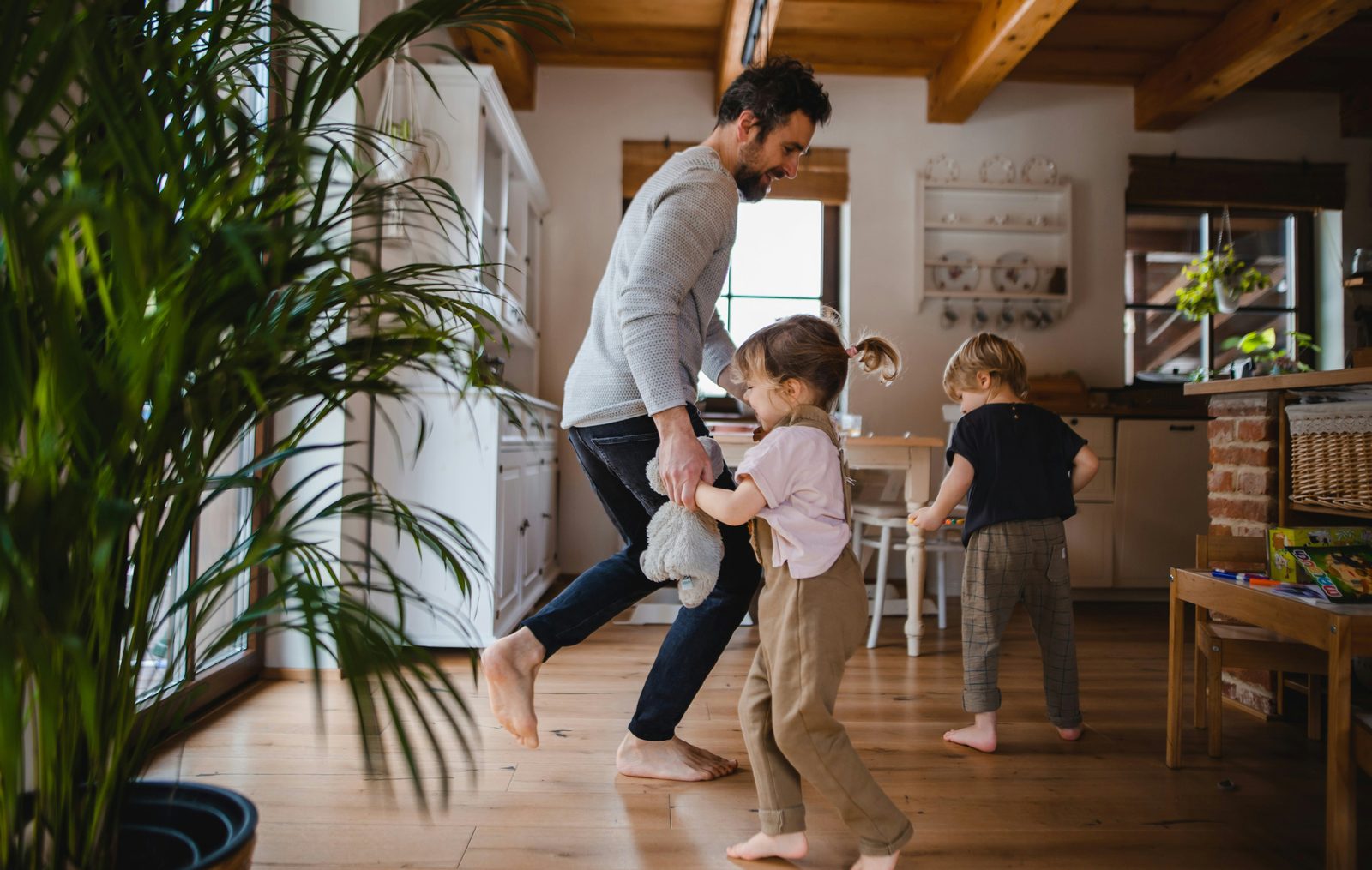 Father and children enjoying a warm, comfortable family home on Vancouver Island